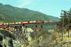 The middle if the train can be seen beneath the tail end as it crosses to the west side of the river.